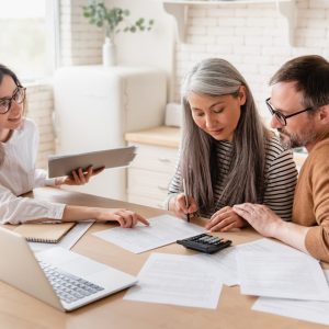 insurance-agent-consulting-mature-family-couple-discussing-health-insurance-signing-contract-deal-e1658813569497.jpg